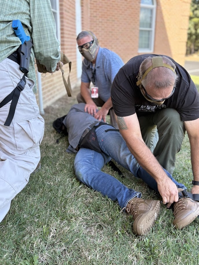 Church security team members practicing emergency medical response during training
