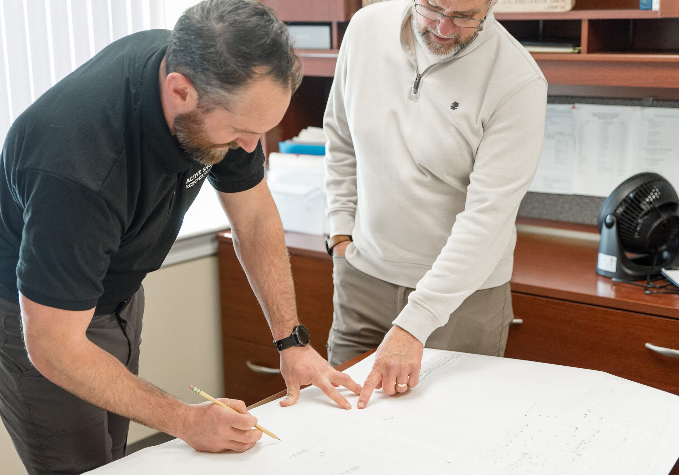 Kyle Sproles reviewing plans during a security vulnerability assessment
